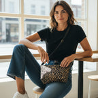 Model wearing shimmering metallic leopard print crossbody bag with luxurious bronze and black pattern, smooth black leather adjustable strap across body by Umpie Handbags