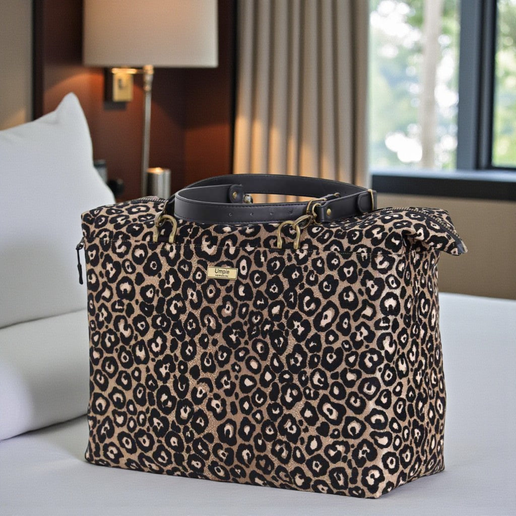 Handmade metallic leopard print weekend bag showing secure zip-top closure and stitched leather straps by Umpie Handbags