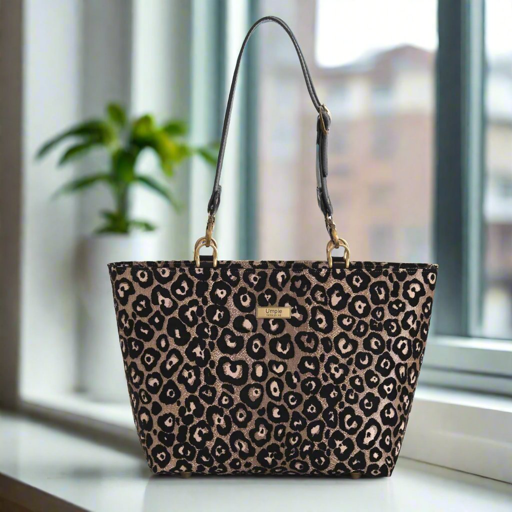 Leopard print shoulder bag with black leather straps