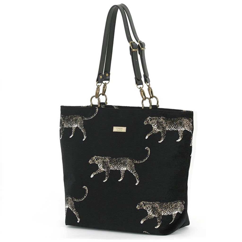 Full front view of leopard tote bag showcasing striking embroidered animal print on black tapestry, comfortable black leather shoulder straps, spacious interior, and individually handcrafted British quality by Umpie Handbags
