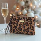 Luxurious hair on leather leopard print clutch bag with gold-tone wrist strap and premium hardware, front view showcasing exotic natural pattern by Umpie Handbags