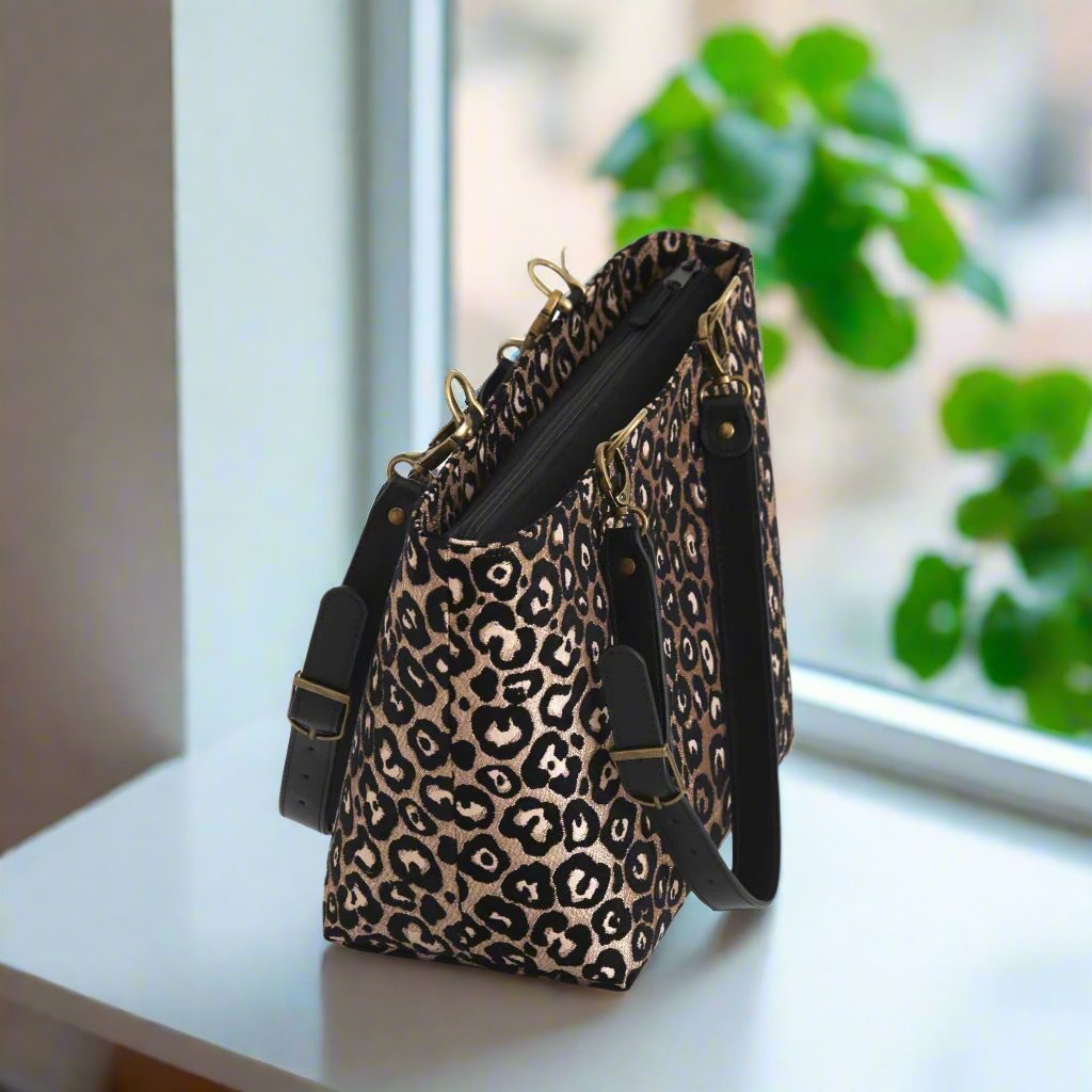 Leopard print shoulder bag with black leather straps - zip-top view