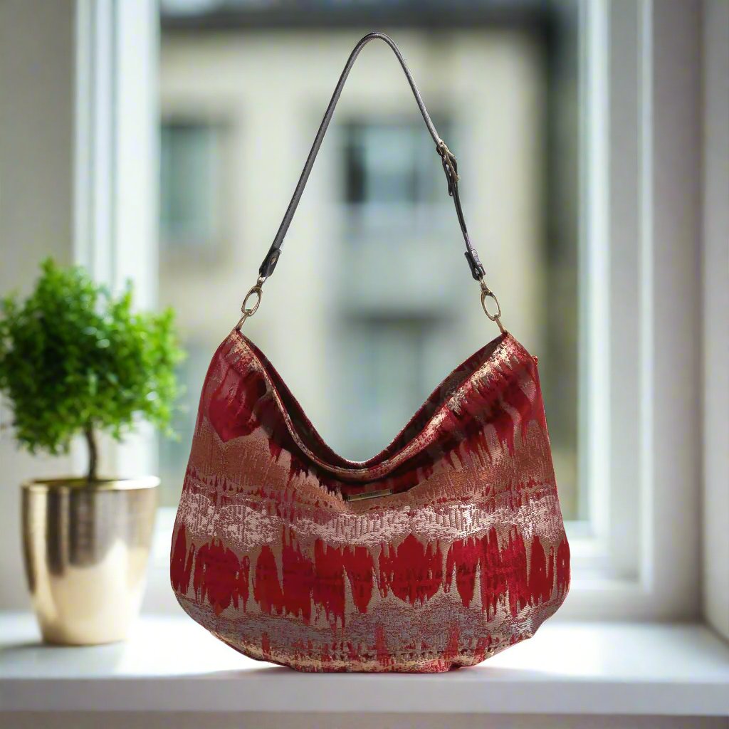 The Red Metallic Hobo Bag with a black leather strap