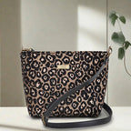 Compact leopard print crossbody bag displayed at an angle, showcasing the eye-catching metallic sheen and structured silhouette with premium black leather strap by Umpie Handbags