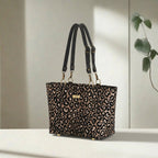 Leopard print shoulder bag displayed at an angle, highlighting the eye-catching metallic sheen, generous proportions, and quality black leather strap detailing by Umpie Handbags
