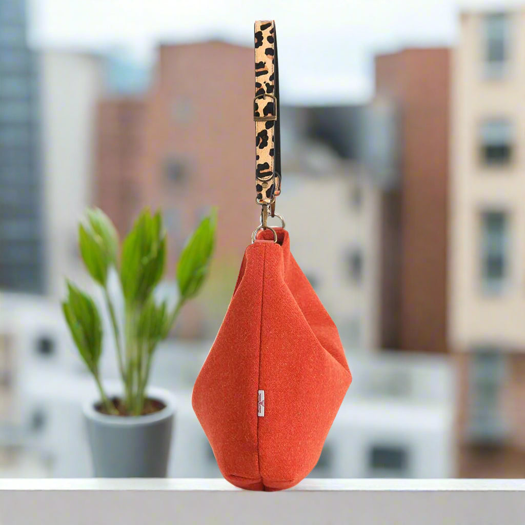 The Orange Harris Tweed Hobo Bag with a Leopard print leather strap - side view