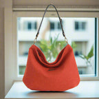 The Orange Harris Tweed Hobo Bag with a Leopard print leather strap - front view