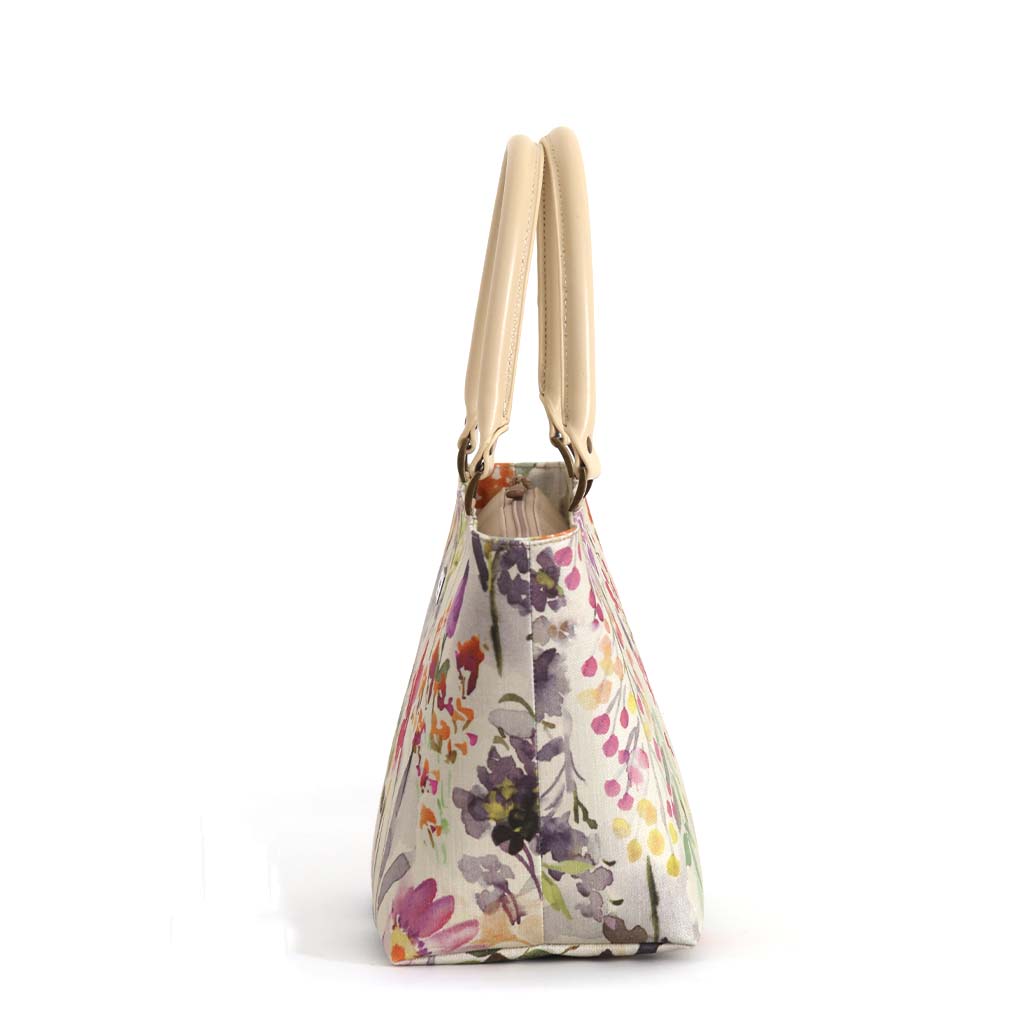 Side profile of Wildflower Handbag on white background showing structured silhouette, firm construction and cream leather handles, handmade in Great Britain by Umpie Handbags