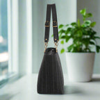 Side profile of Savile Row-inspired pinstripe shoulder bag showcasing traditional tailoring excellence and Yorkshire craftsmanship with structured design