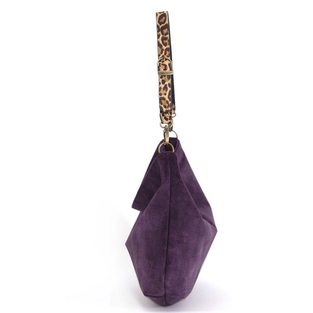 A purple velvet hobo bag with a leopard-print leather strap and gold-tone hardware, shown against a plain white background, by Umpie Handbags