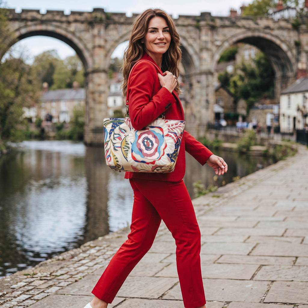 Model wearing the red floral linen shoulder bag with red leather handles at the Knaresborough Viaduct in Yorkshire by Umpie Handbags