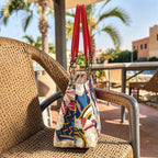 Side view of the Red Floral Shoulder Bag revealing firm structured construction and colourful red leather handles, by Umpie Handbags