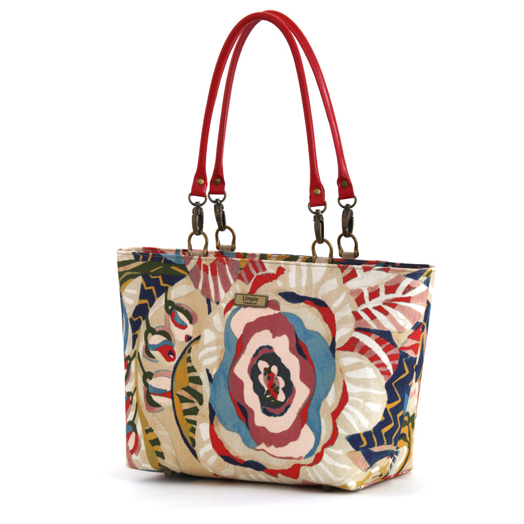 The front view of the red floral shoulder bag with red leather handles, handmade in Yorkshire by Umpie Handbags.