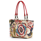 The front view of the red floral shoulder bag with red leather handles, handmade in Yorkshire by Umpie Handbags.