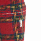Close-up of a red tartan Harris Tweed wool with the Harris Tweed Orb  label stitched into the side seam, by Umpie Handbags