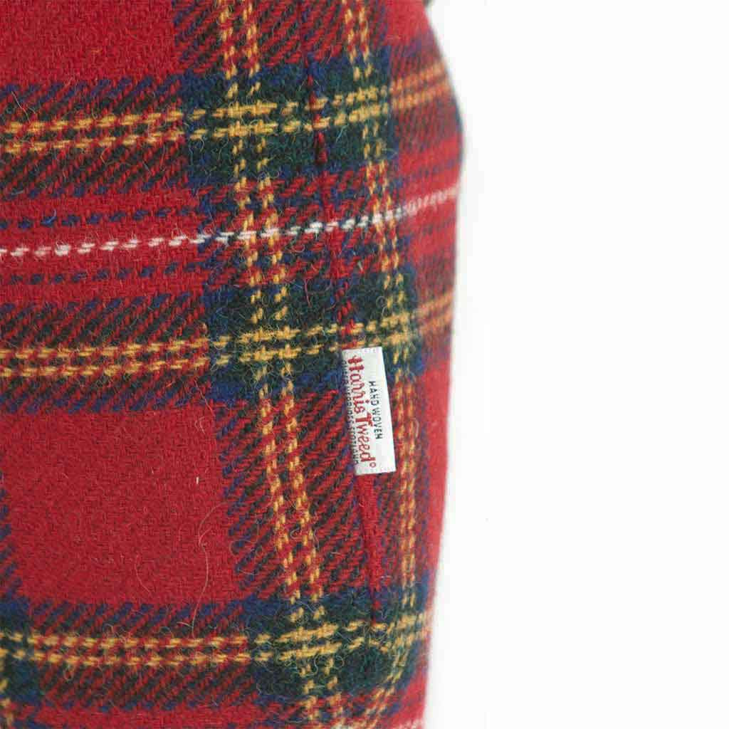 Close-up of a red tartan Harris Tweed wool with the Harris Tweed Orb  label stitched into the side seam, by Umpie Handbags