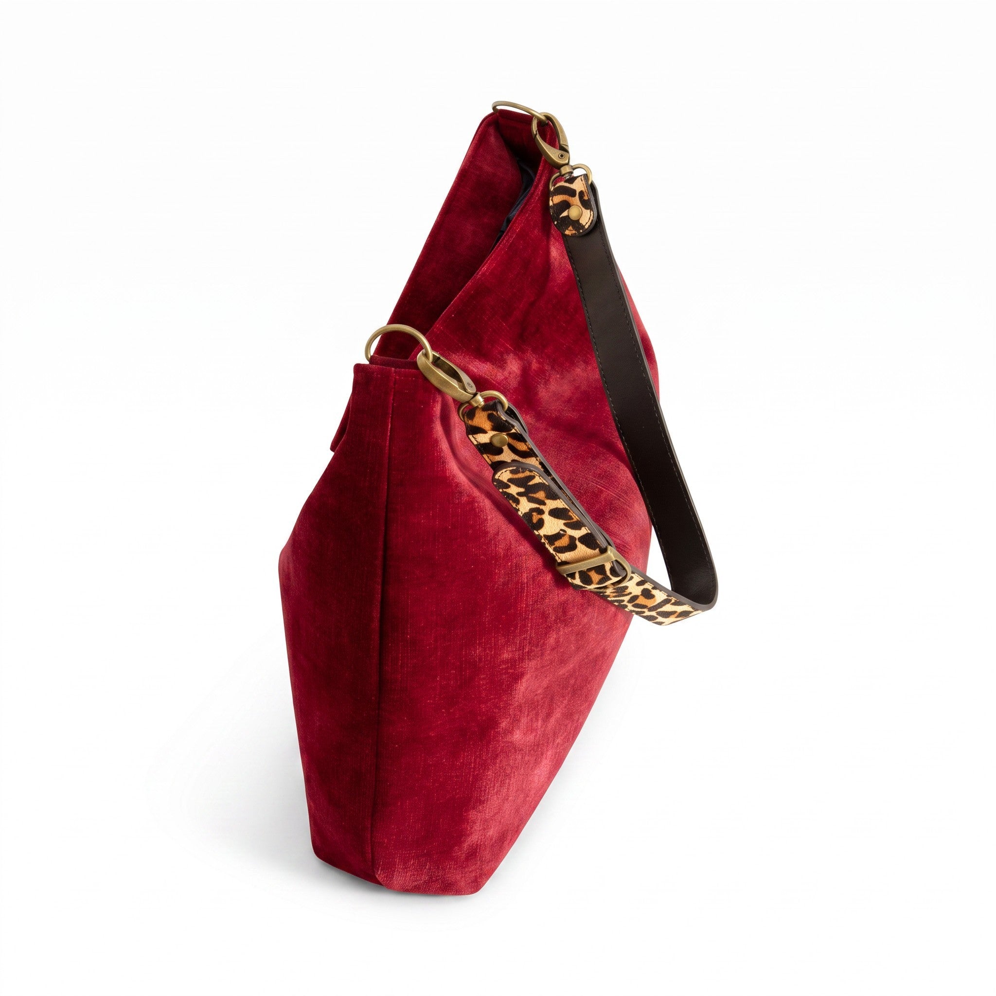 Top-zip detail of the red velvet hobo bag showing antique gold zip closure and leopard print leather strap by Umpie Handbags
