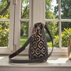 Side profile view of gold metallic crossbody bag revealing 11cm base width with protective metal feet, structured silhouette, black leather strap attachment, and practical dimensions for everyday elegance by Umpie Handbags