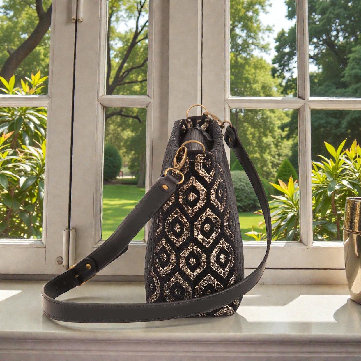 Side profile view of gold metallic crossbody bag revealing 11cm base width with protective metal feet, structured silhouette, black leather strap attachment, and practical dimensions for everyday elegance by Umpie Handbags