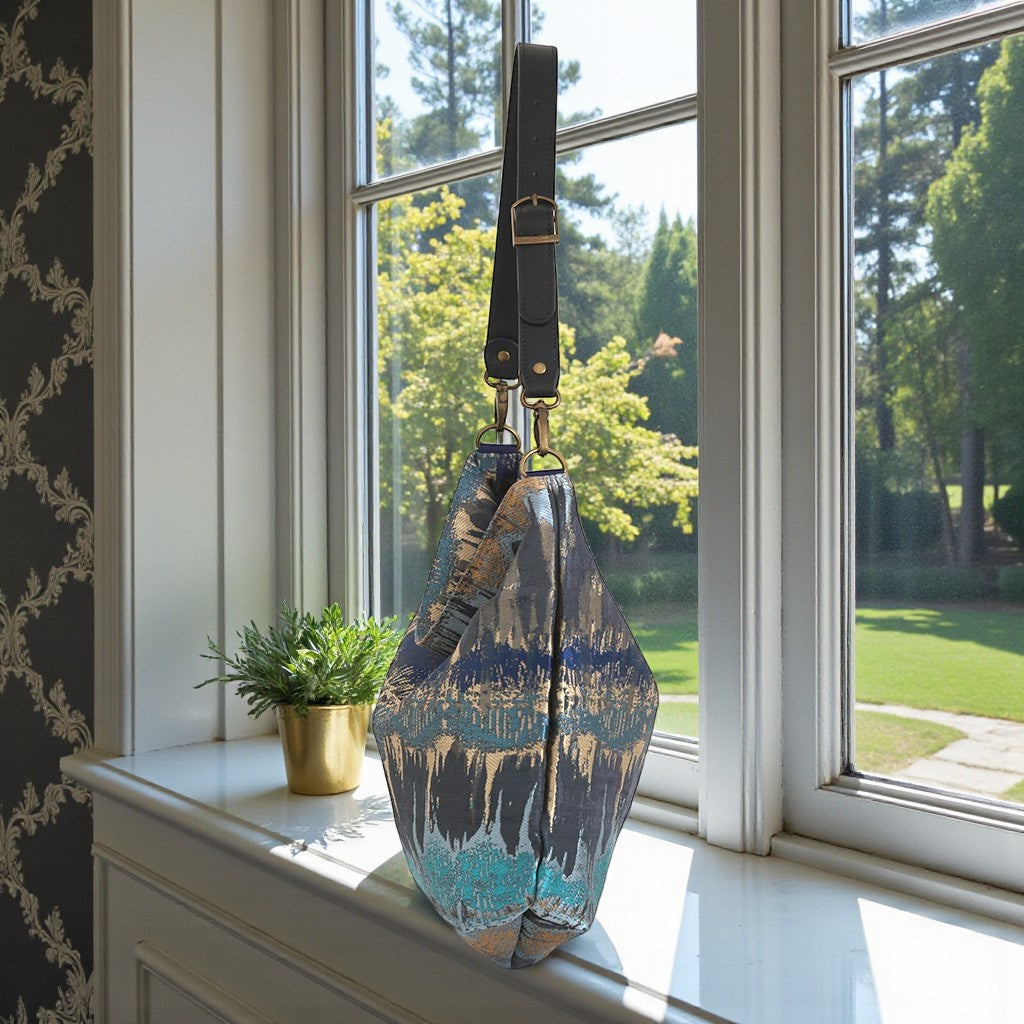 Side profile of Teal Metallic Hobo Bag displaying relaxed hobo silhouette and adjustable black leather strap by Umpie Handbags