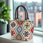 Hexagon handbag with multicoloured tapestry fabric and black leather handles by Umpie Handbags