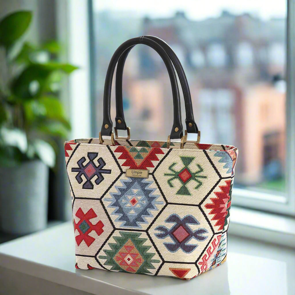 Hexagon handbag with multicoloured tapestry fabric and black leather handles by Umpie Handbags