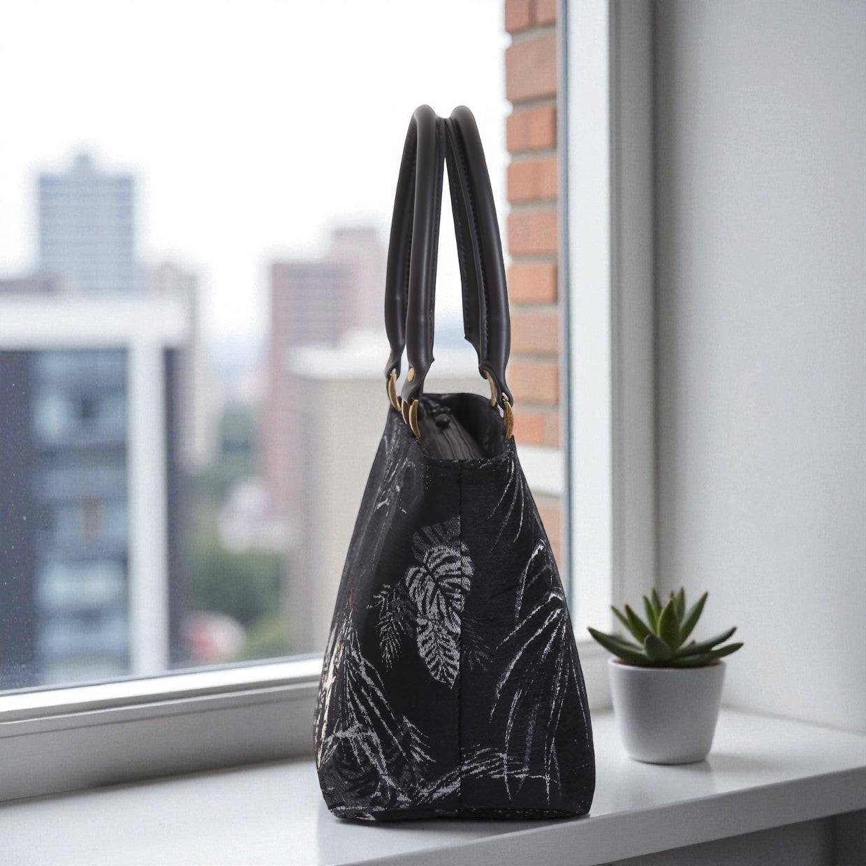 Side profile of tiger-print handbag showcasing 16cm base width, firm structured construction, metal protective feet and elegant proportions by Umpie Handbags