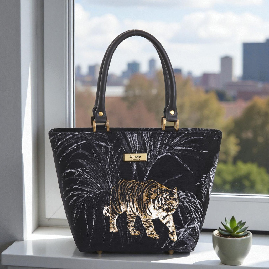 Front view of striking tiger-print tapestry handbag with bold exotic pattern, premium black leather handles, zip-top closure and British handcrafted quality by Umpie Handbags