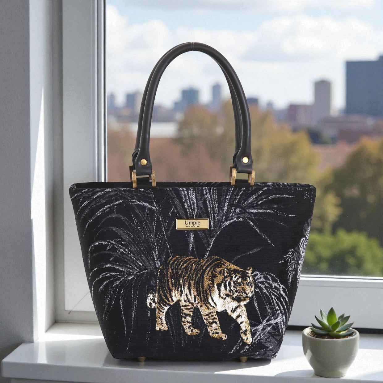 Front view of striking tiger-print tapestry handbag with bold exotic pattern, premium black leather handles, zip-top closure and British handcrafted quality by Umpie Handbags