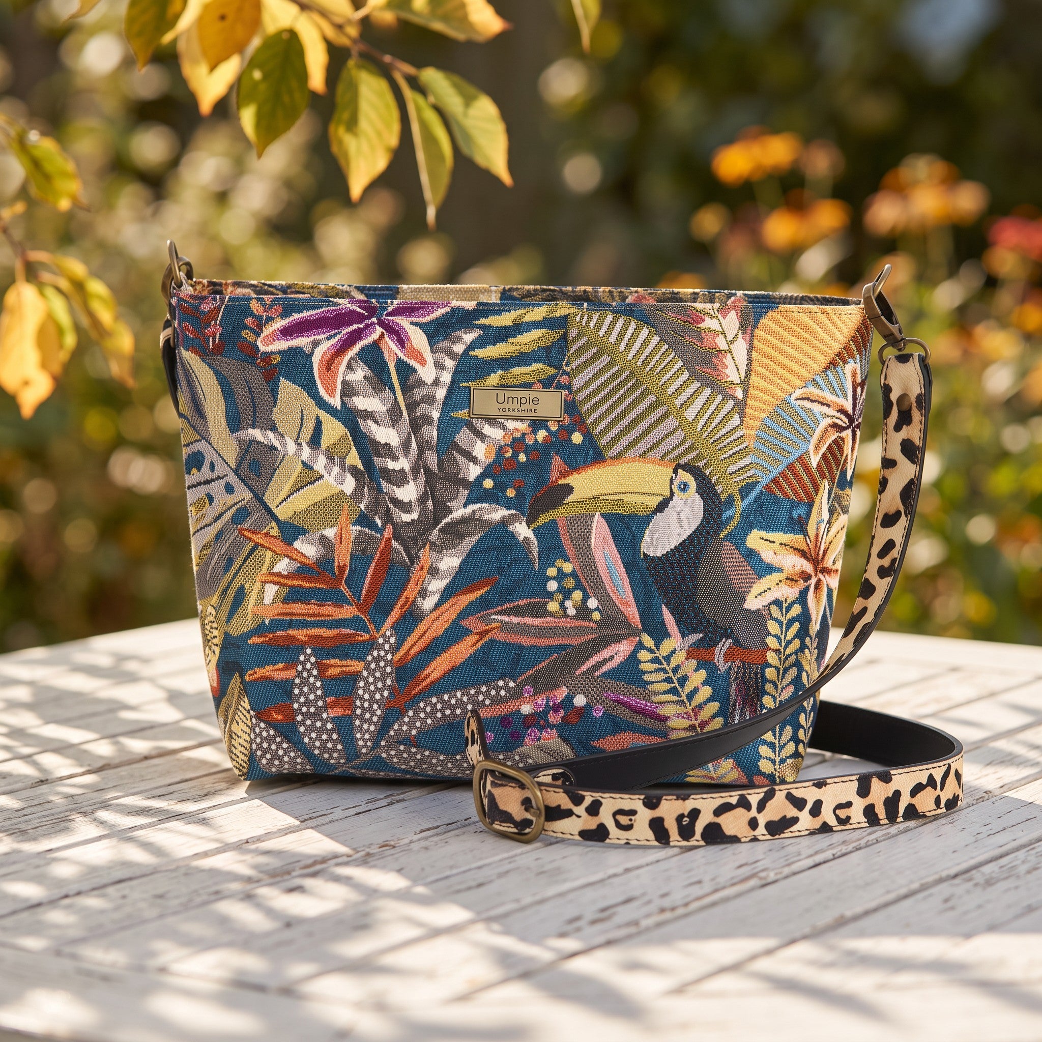 The Toucan Tapestry Crossbody Bag in a late summer early autumn setting  highlighting the beautifu lrich colours of this unique handbag, by Umpie Handbags