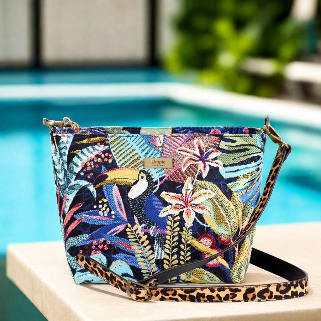 The Floral Crossbody Bag with a Leopard print leather strap.