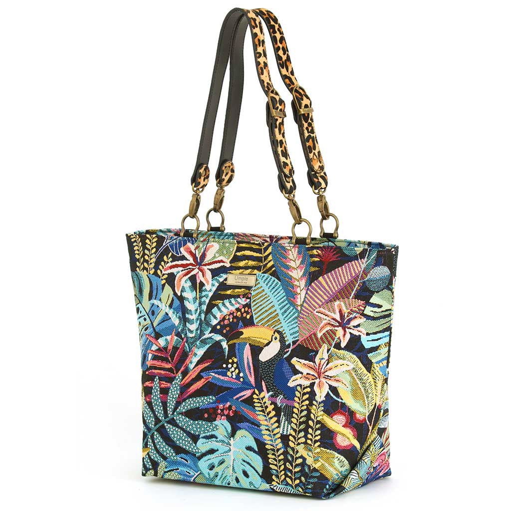 Angled front view of Tropical Toucan Shoulder Bag on white background, richly woven toucan and jungle foliage tapestry on navy with leopard print leather handles and antique gold hardware, by Umpie Handbags