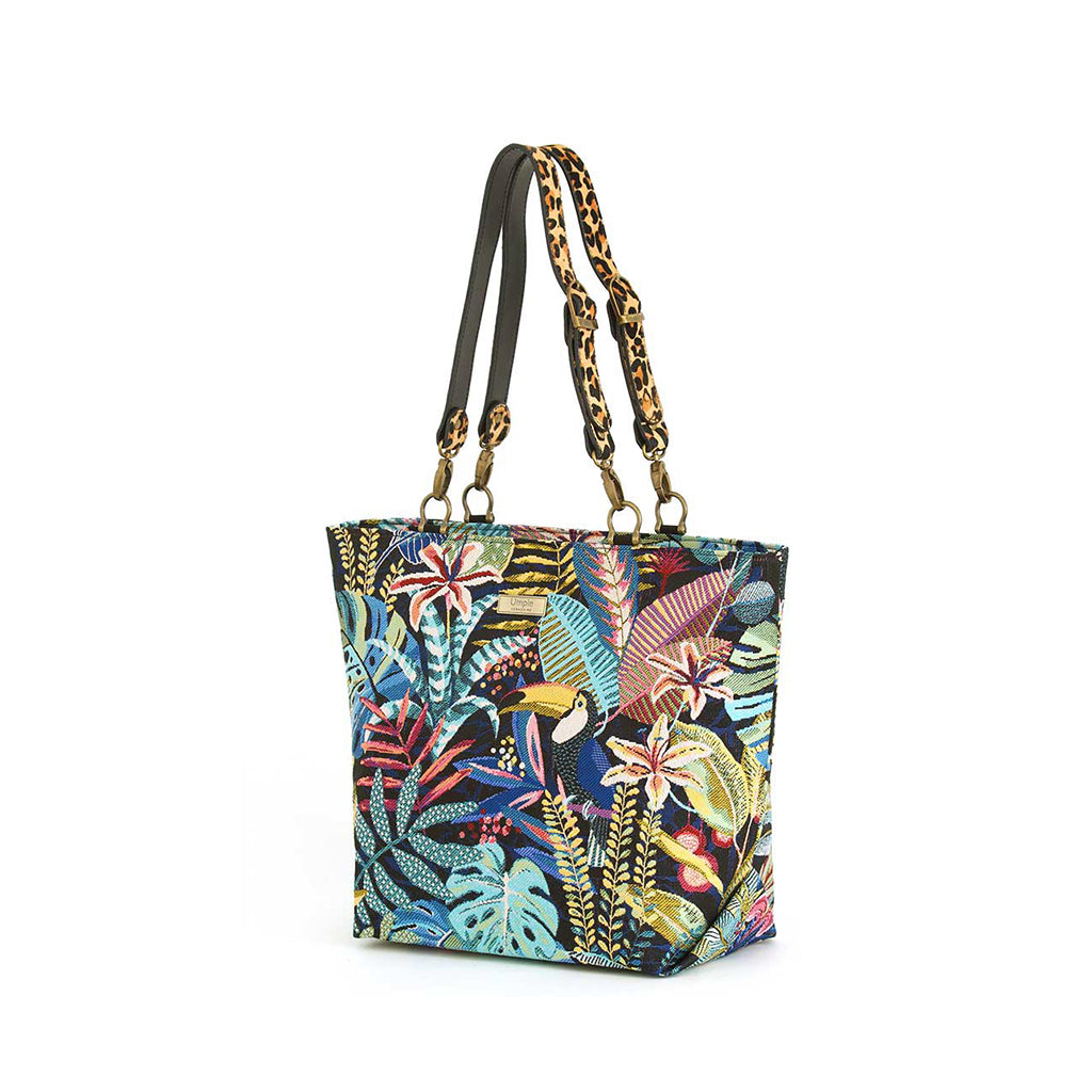 Front view of Tropical Tapestry Tote Bag on white background, richly woven toucan and jungle foliage tapestry on navy with leopard print leather handles and antique gold hardware, by Umpie Handbags
