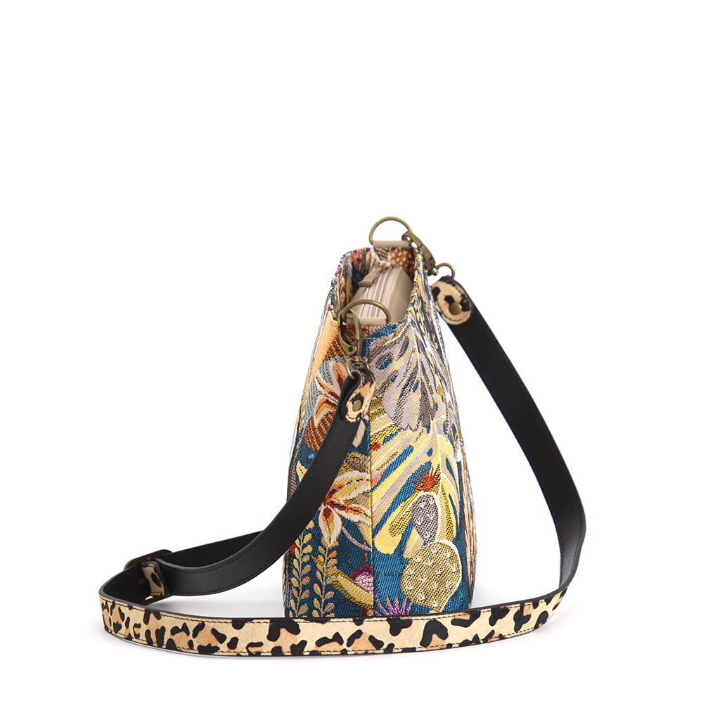 Toucan Tapestry Crossbody Bag side view showing zip-top, structured interior with internal pockets, leopard print leather strap with antique gold fittings, by Umpie Handbags