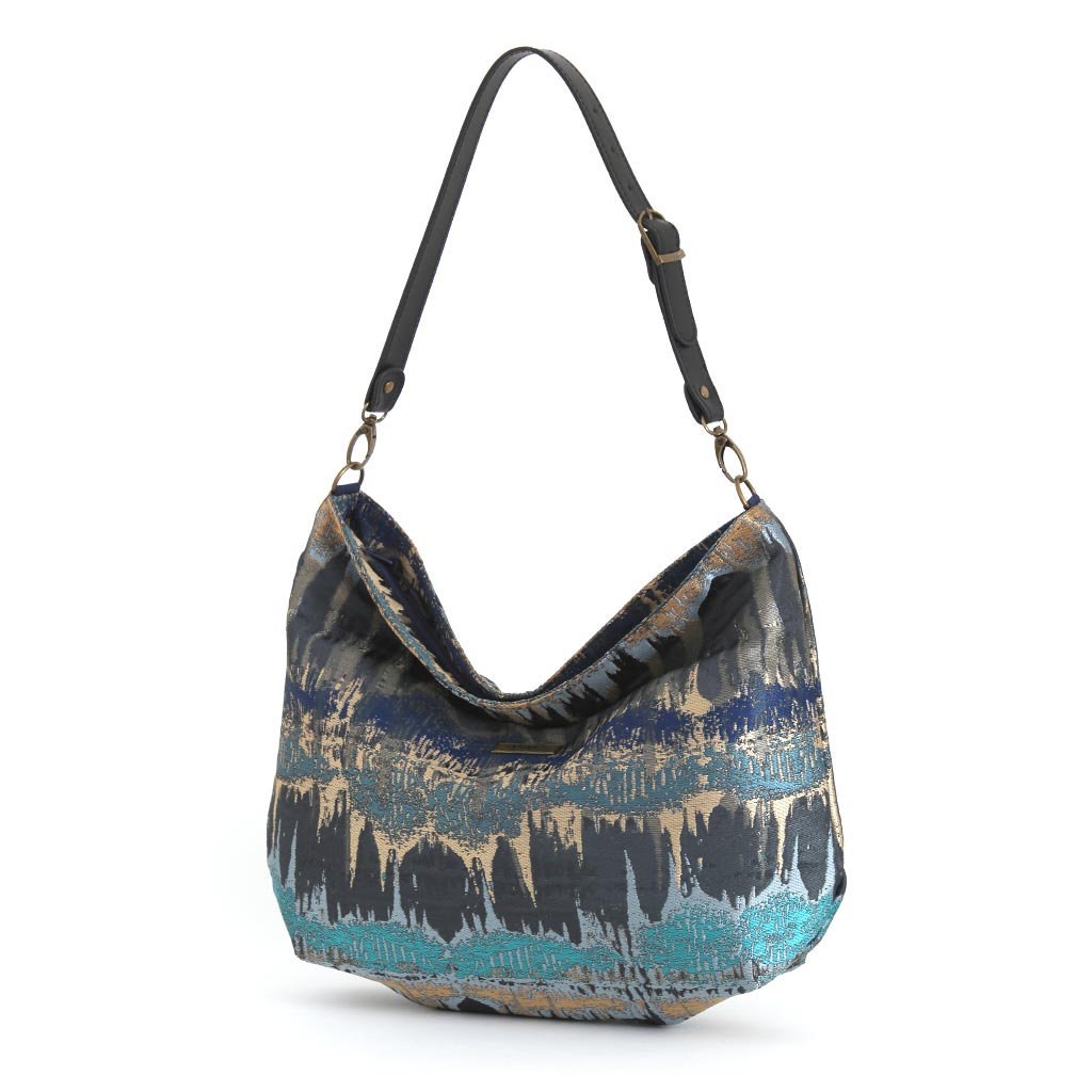 Teal Metallic Hobo Bag worn on shoulder showing shimmering brocade fabric and vibrant teal colour by Umpie Handbags