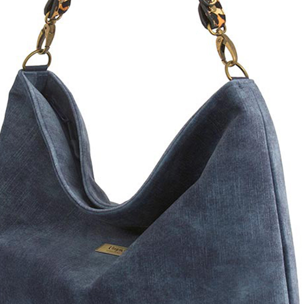 Luxurious blue velvet hobo bag with bold leopard print leather strap, close-up view view showing rich texture and slouchy silhouette by Umpie Handbags