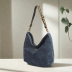 Luxurious blue velvet hobo bag with bold leopard print leather strap, front view showing rich texture and slouchy silhouette by Umpie Handbags