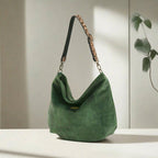 Luxurious Green velvet hobo bag with bold leopard print leather strap, front view showing rich texture and slouchy silhouette by Umpie Handbags