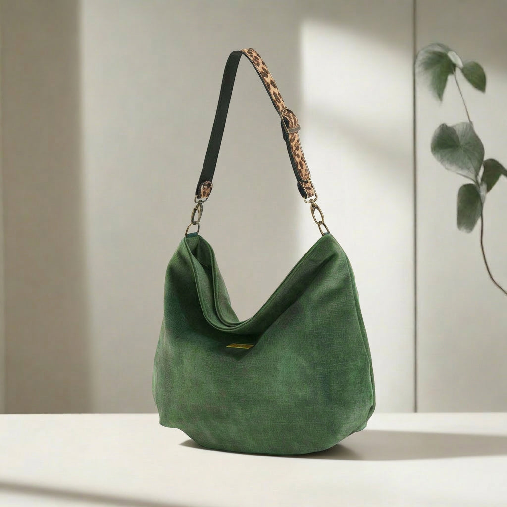 Luxurious Green velvet hobo bag with bold leopard print leather strap, front view showing rich texture and slouchy silhouette by Umpie Handbags