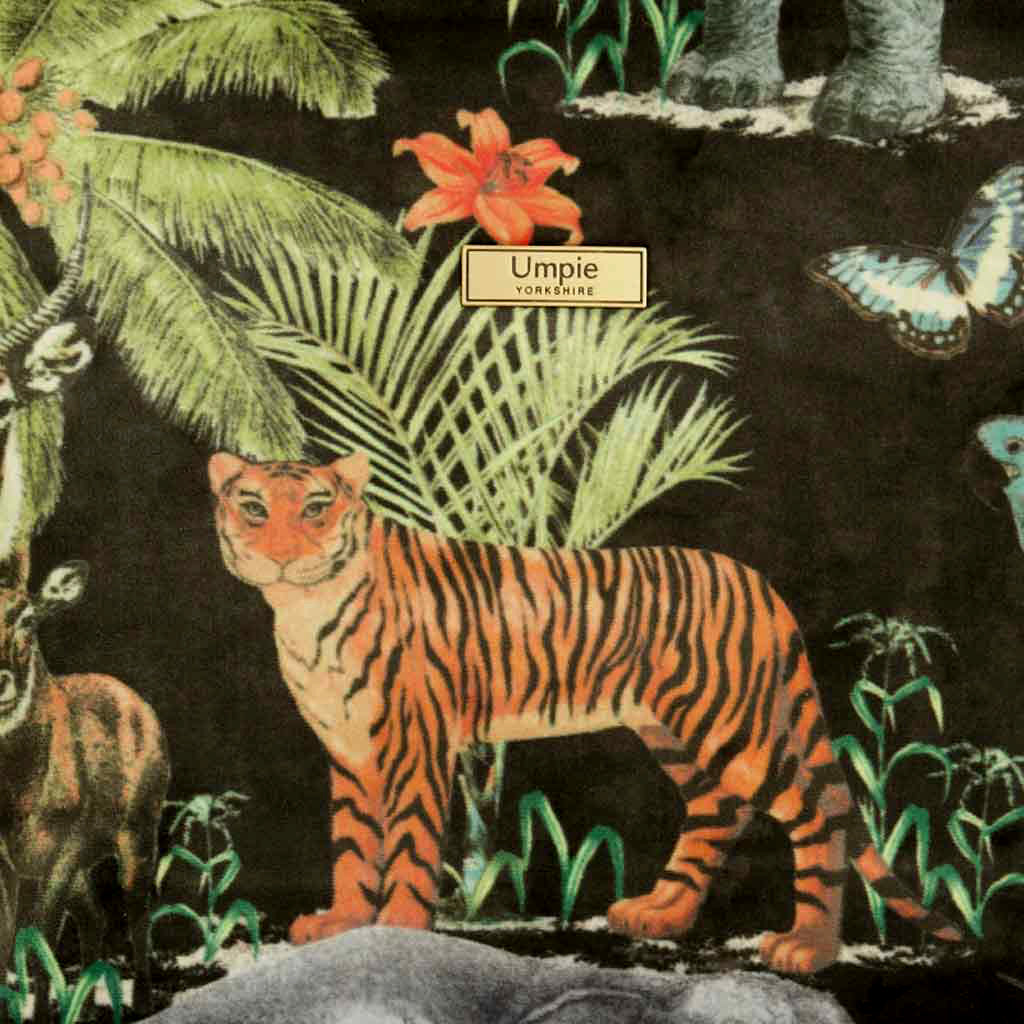 Fabric view of the luxurious printed velvet tiger crossbody bag with leopard print leather strap showing rich texture and exotic pattern by Umpie Handbags
