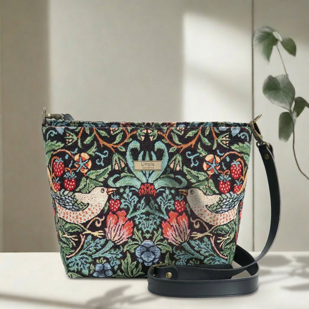 William Morris Crossbody Bag worn across body showing iconic Strawberry Thief tapestry design and black leather strap by Umpie Handbags