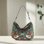 Front view of William Morris Hobo Bag featuring Strawberry Thief pattern with thrushes and botanical blooms by Umpie Handbags