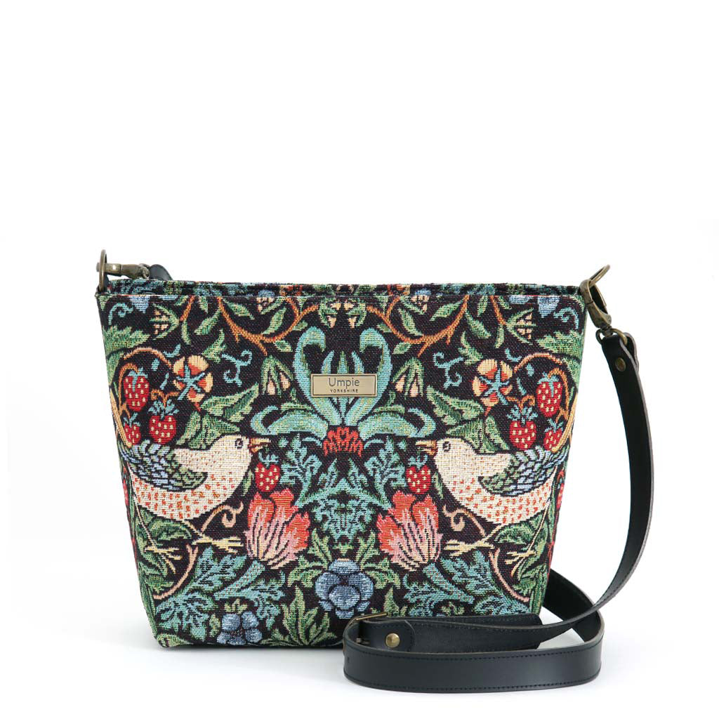 William Morris Crossbody Bag worn across body showing iconic Strawberry Thief tapestry design and black leather strap by Umpie Handbags