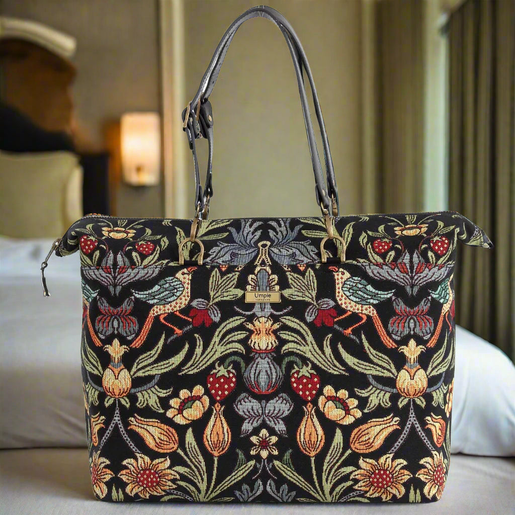 Close-up of William Morris travel bag displaying secure zip-top closure and detailed Morris pattern tapestry with quality stitching and robust black leather trim by Umpie Handbags