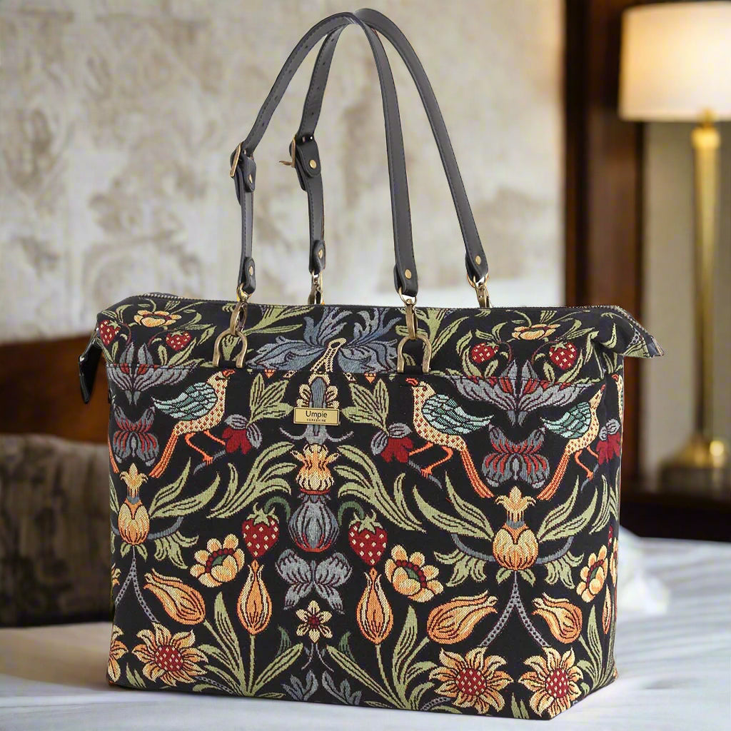 William Morris weekender bag showcasing spacious design with iconic Arts and Crafts movement pattern, premium tapestry construction, and luxurious black leather accents by Umpie Handbags