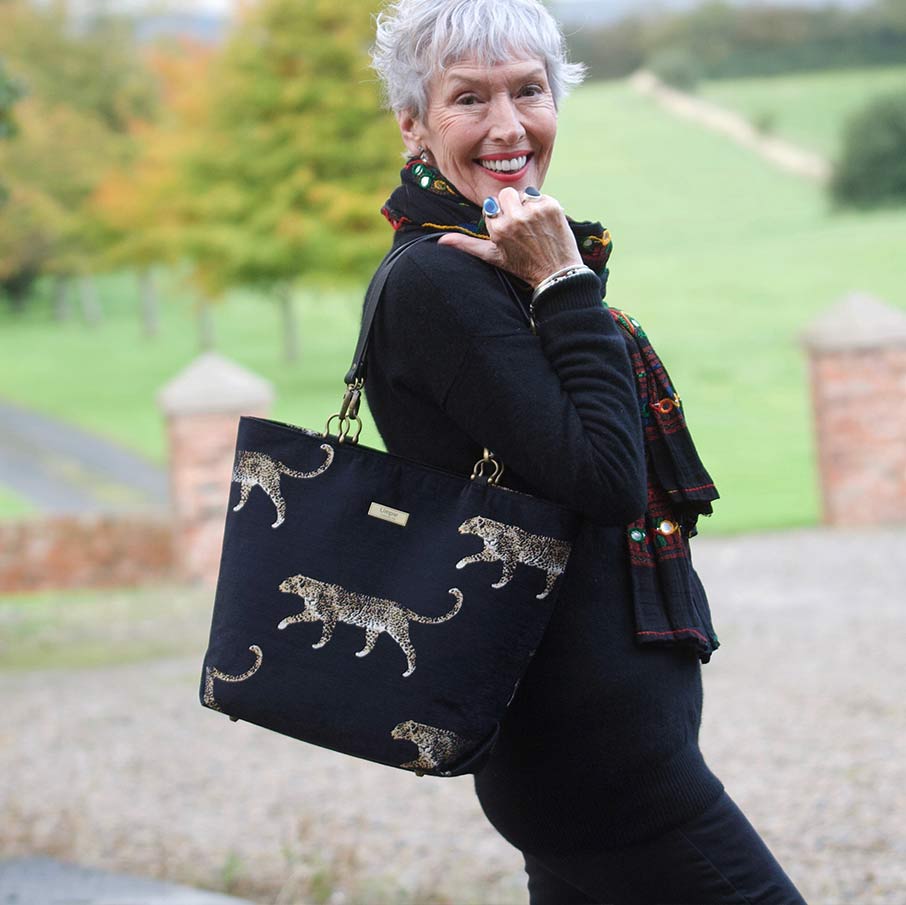 Woman holding the Leopard Print Tote Bag Black/Gold, by Umpie Handbags