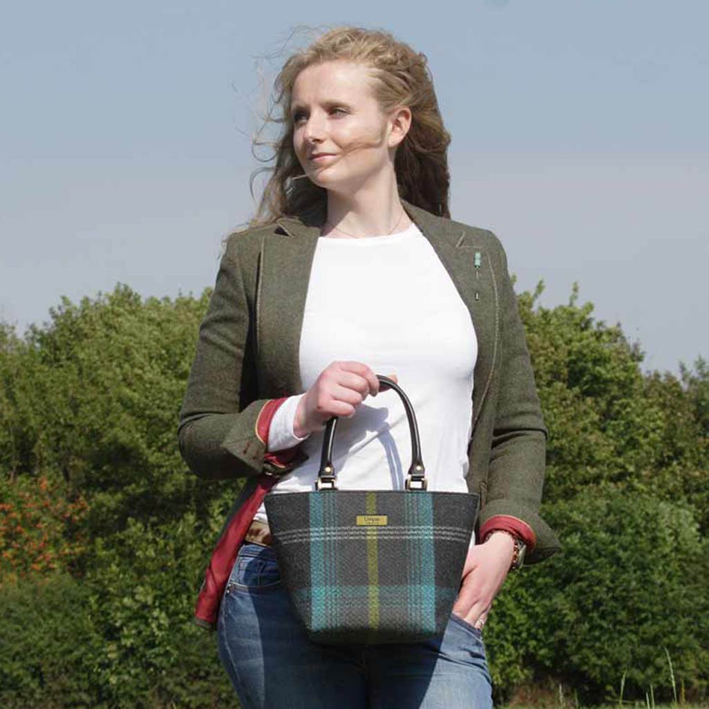 Woman holding the Black Checked Handbag with black leather handles by Umpie Handbags