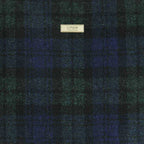 Exquisite Harris Tweed Black Watch Tartan weave close-up - authentic Scottish wool showcasing centuries of Hebridean textile mastery